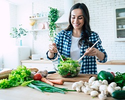 Smiling woman preparing healthy meal at home